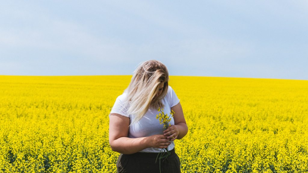 woman in field of flowers