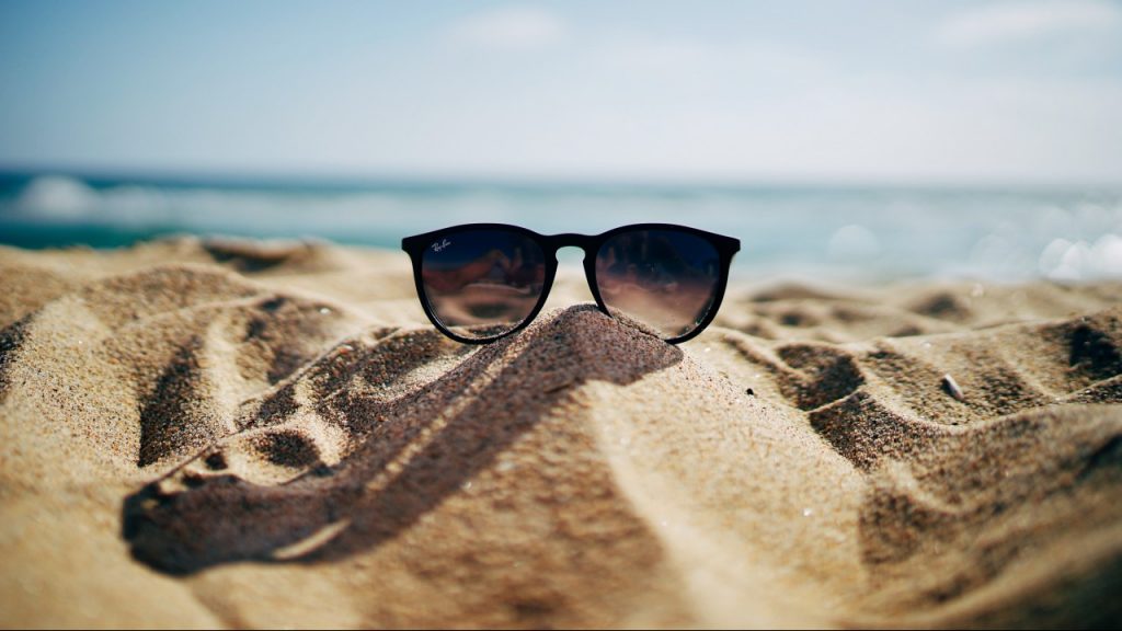 sunglasses on sandy beach