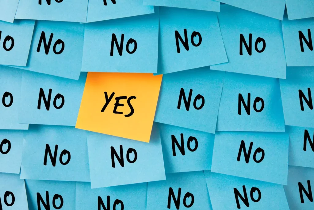 a sticky note saying yes amongst all other sticky notes saying no