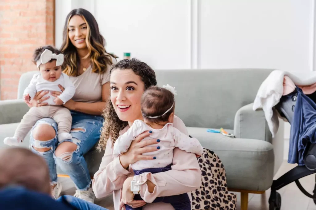 two young women holding their babies and smiling - dreams of being a mother