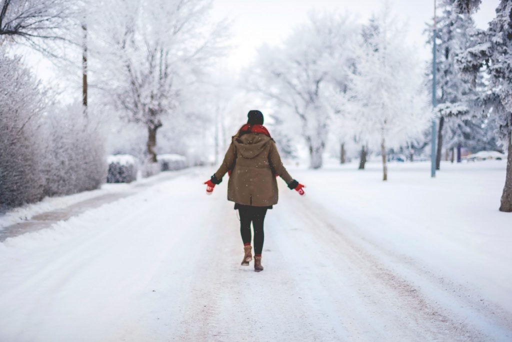 Woman standing alone on a snowy street