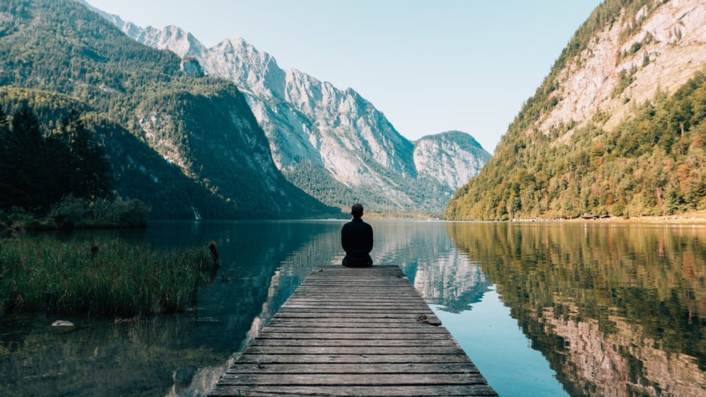 man sitting on dock