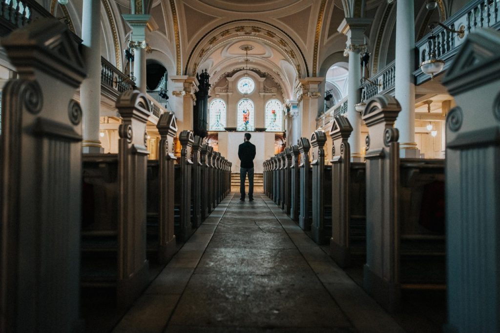 man standing in front of sanctuary