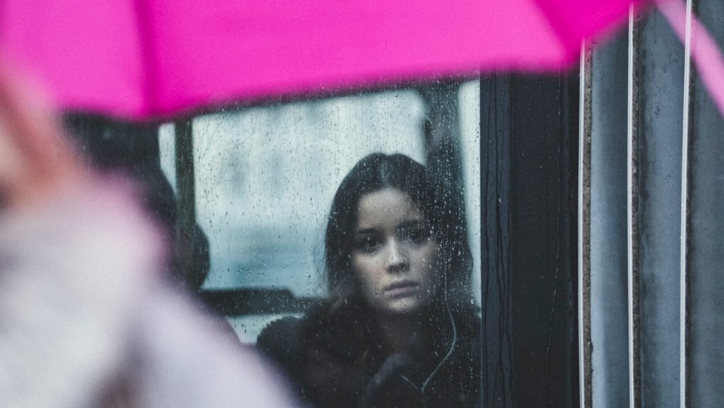 sad woman pink umbrella
