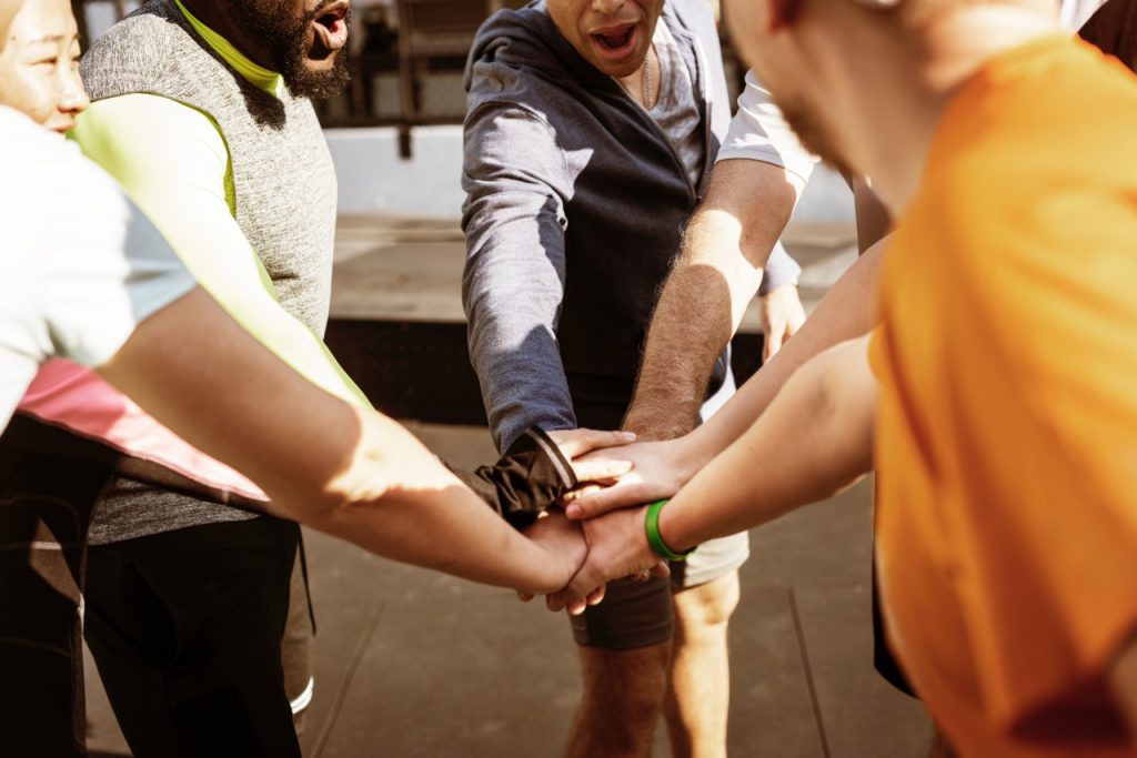 Group of people putting their hands together