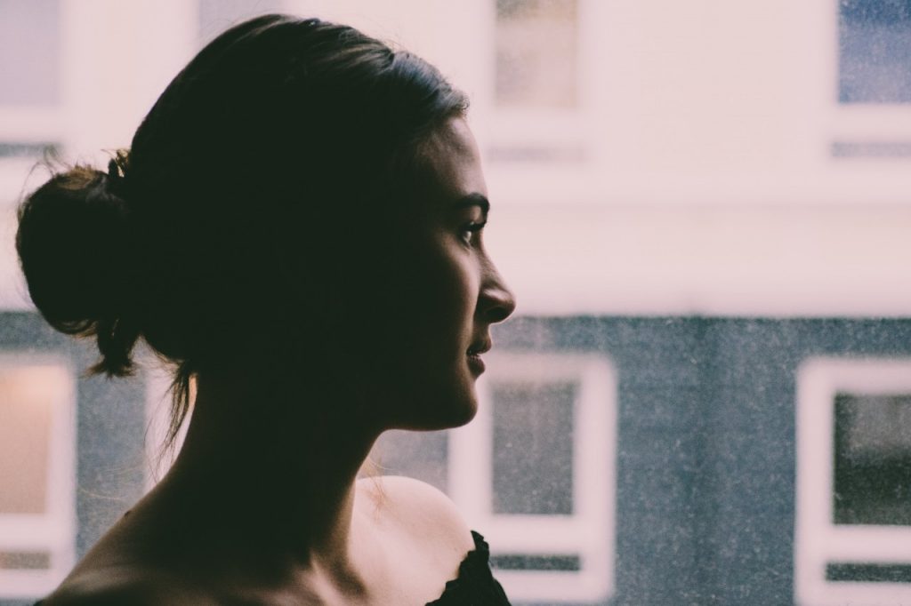 Woman looking out window