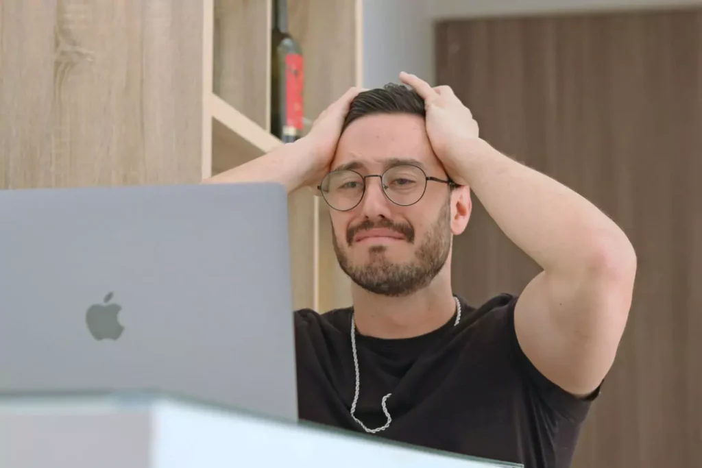 a sad man with hands on his head, reading about a leader's moral failure