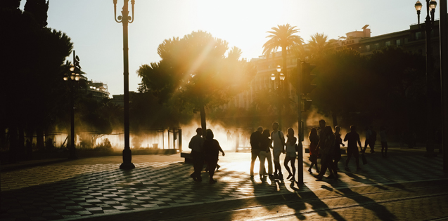 People walking in a city at sunset