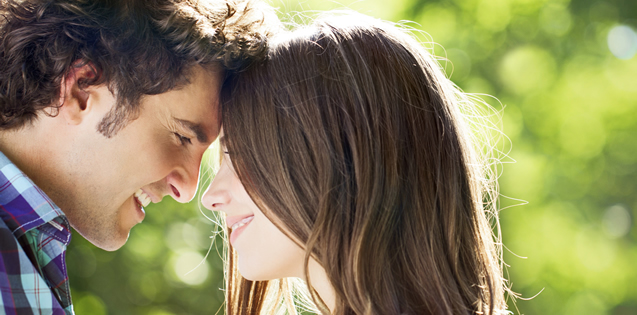 couple head to head smiling at one another