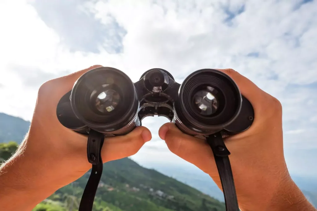 looking through binoculars, the God who sees