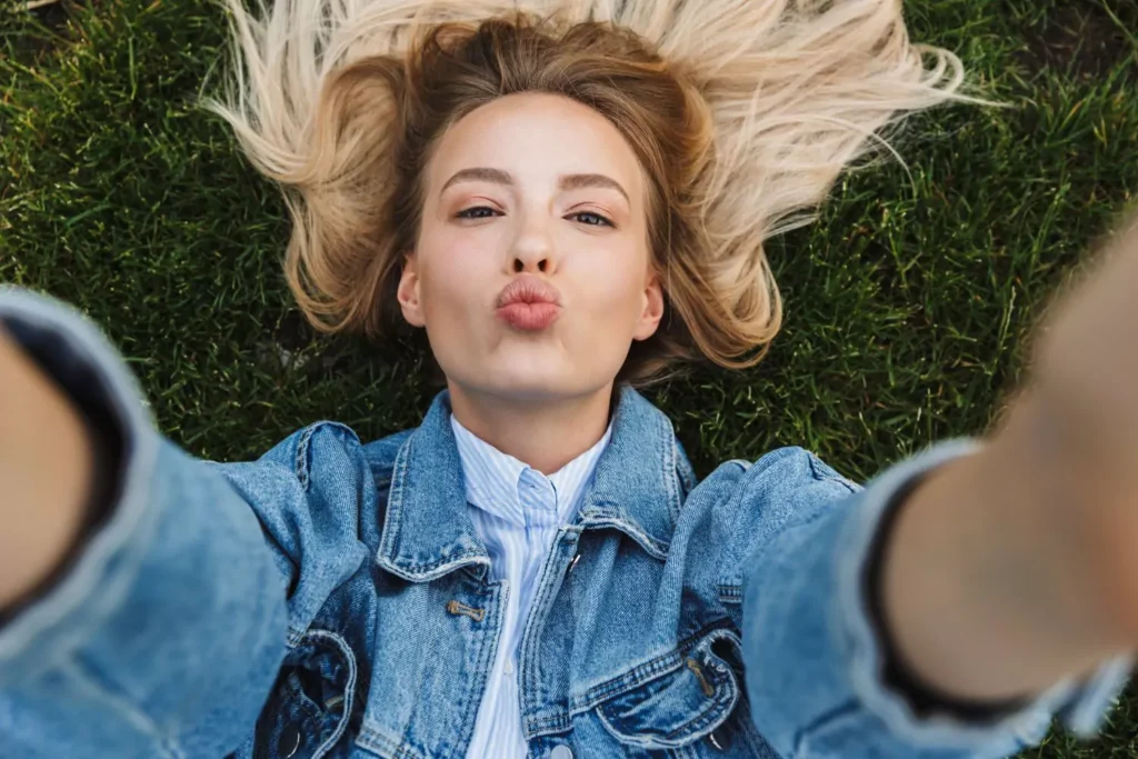 a woman making a kissy face at the camera, unattractive