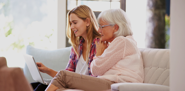 young adult woman talking with an elderly woman