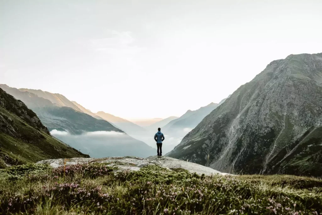 a woman beholding God's creation, looking at a mountain scape