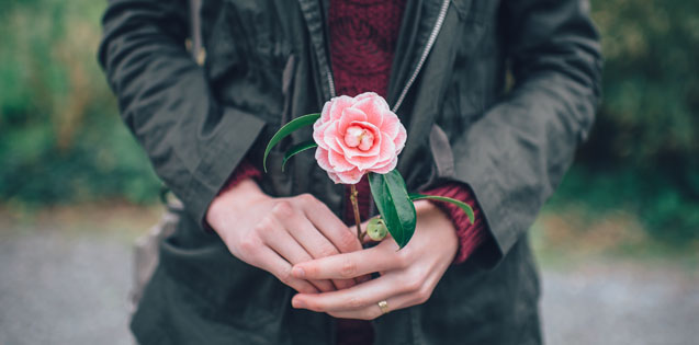 Woman holding pink flower