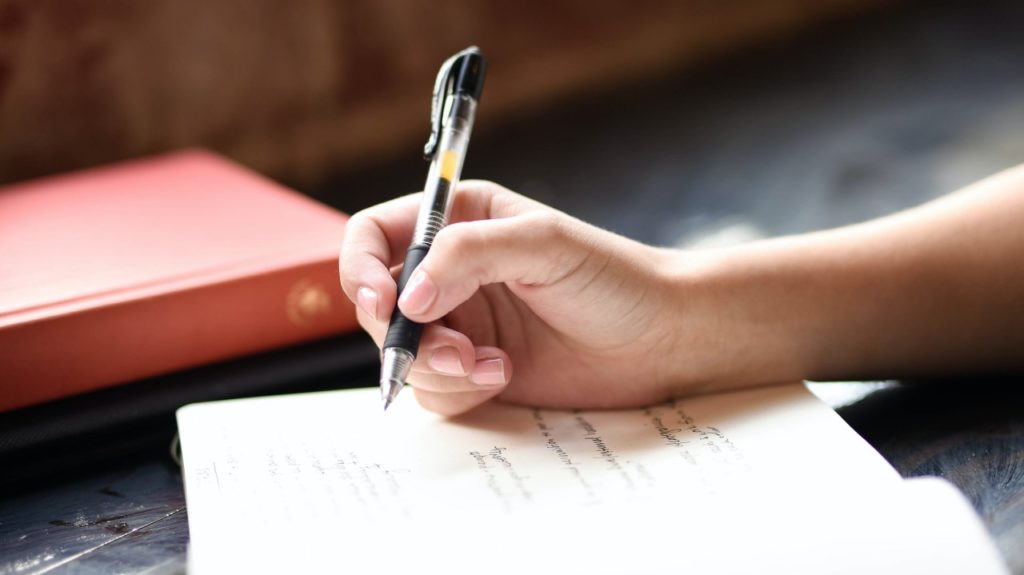 person writing letter