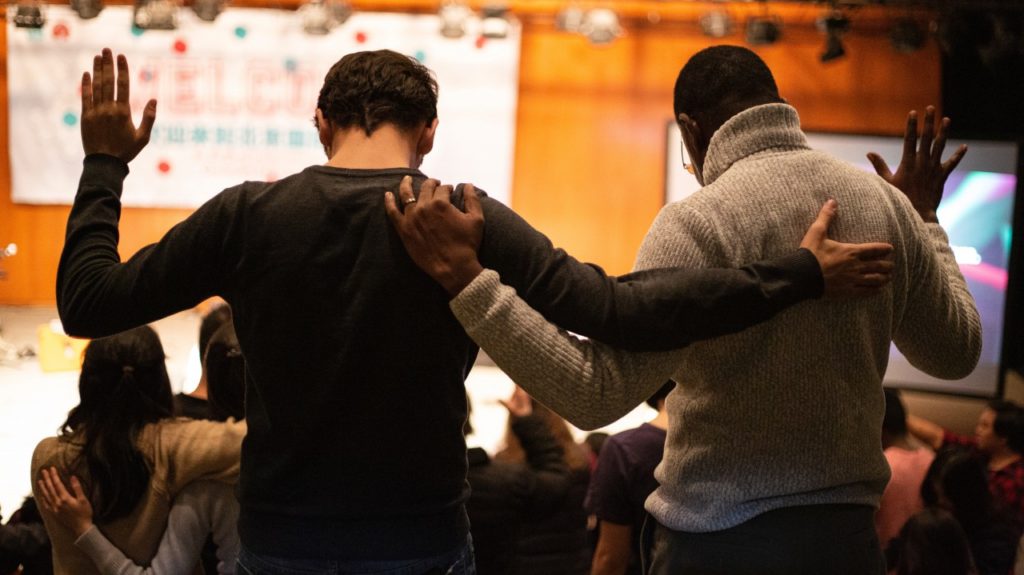 men worshiping together