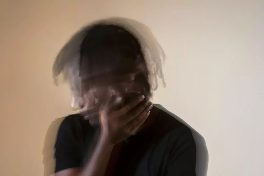 a blurry image of a man turning his head, the image of the many faces of depression