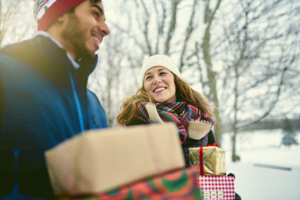 Couple outside holding gifts