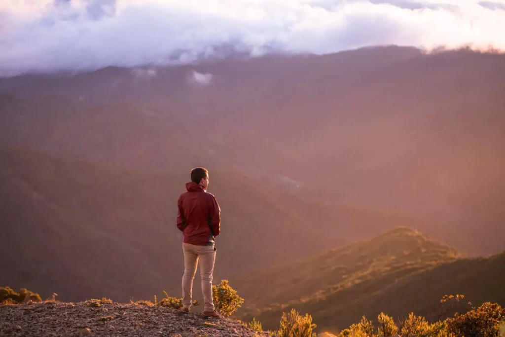 a man standing on a mountain, he has a spirit of restlessness
