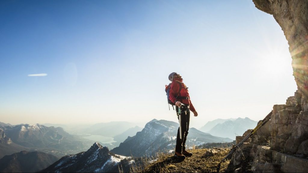 Man looking up at mountain