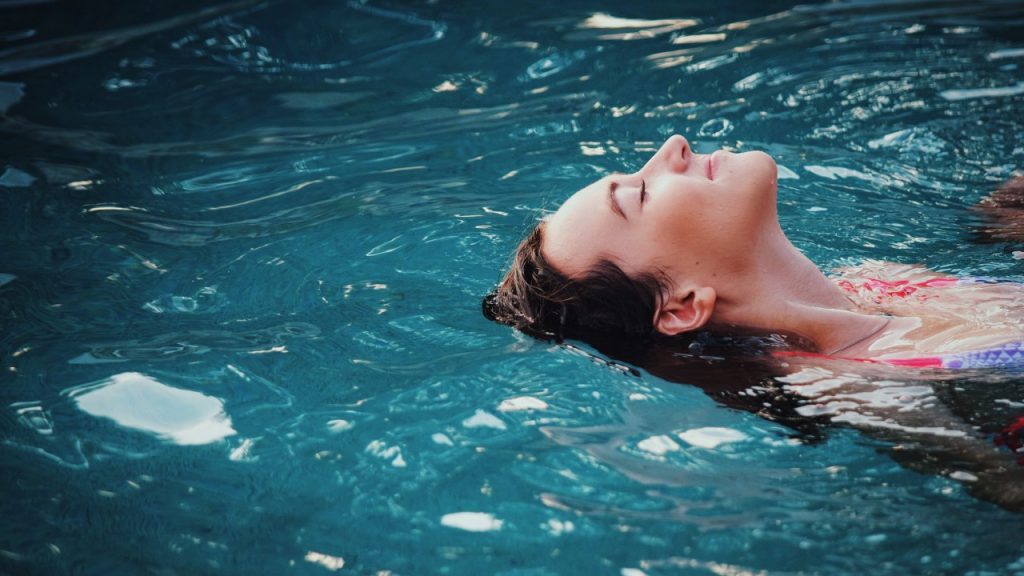 woman floating in pool