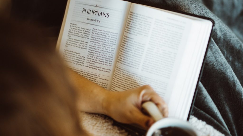 woman reading bible with coffee