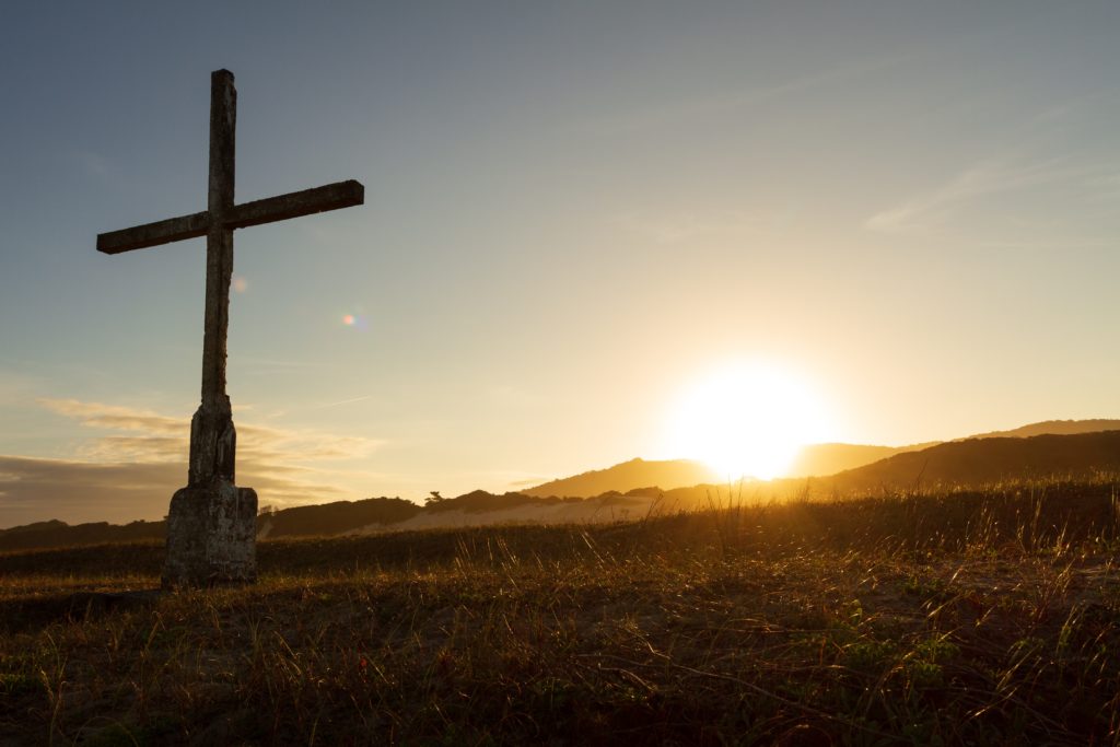 Cross with a sunset in the background