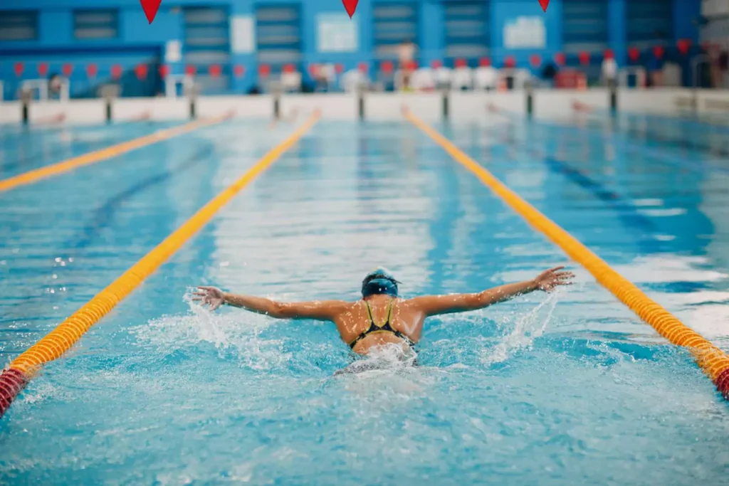 a woman swimming in her lane