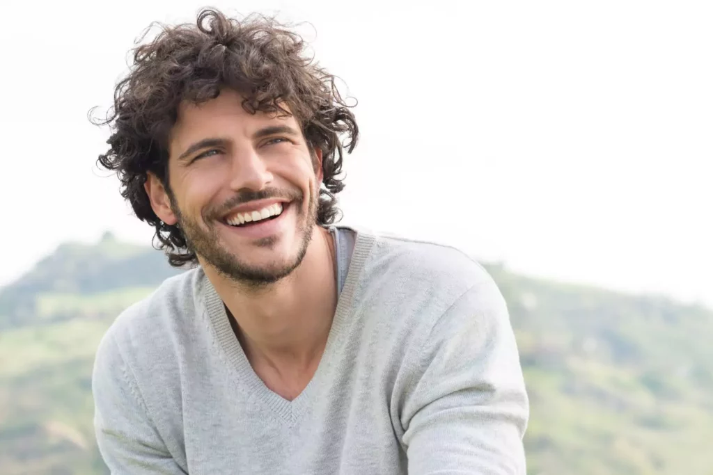 a man smiling, committed to singleness