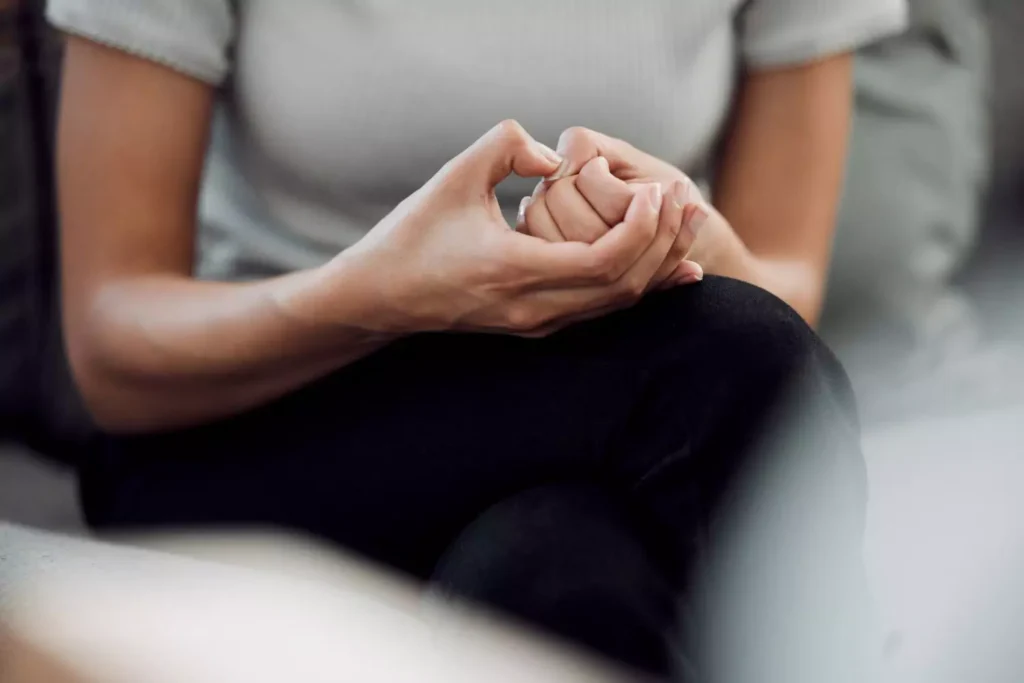 a woman picking at her fingers because she has anxiety