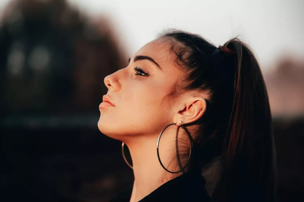 the profile of a single woman looking up at the sky thinking Is Jesus enough?