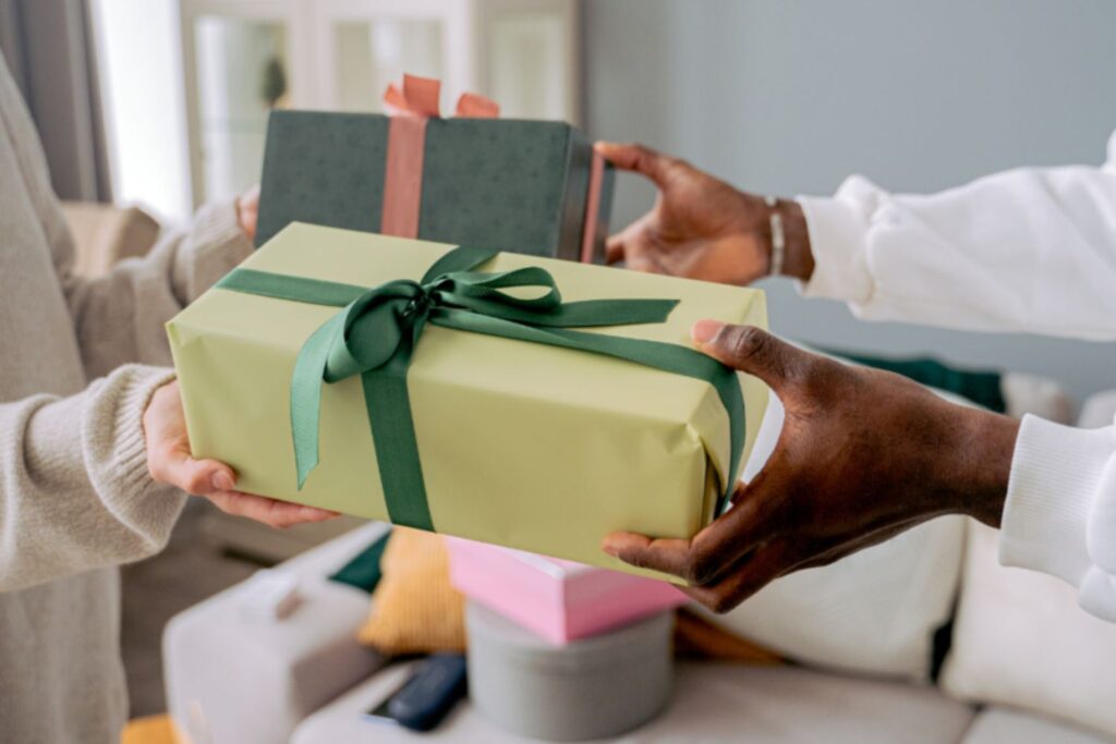 two people exchanging gifts