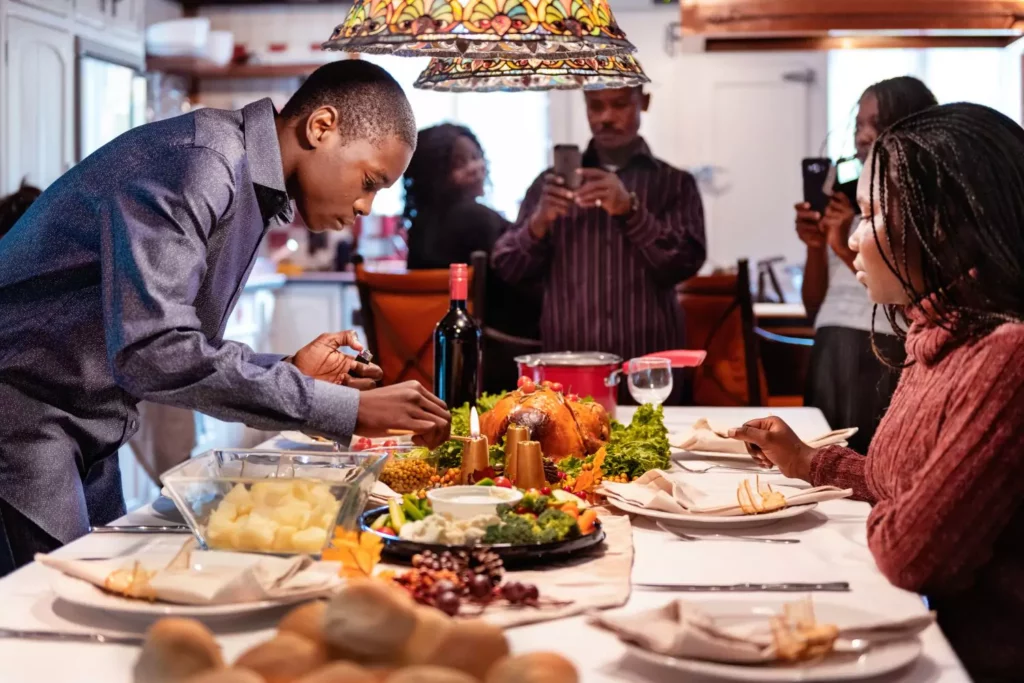 a family gathering around the dinner table for Thanksgiving