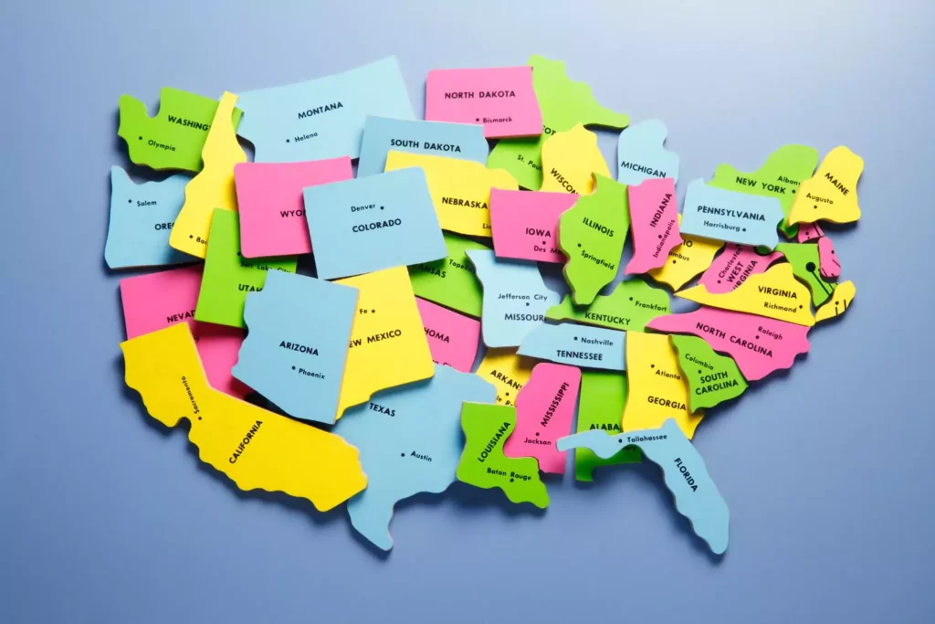 colorful block pieces of a United States of America puzzle - best states for dating