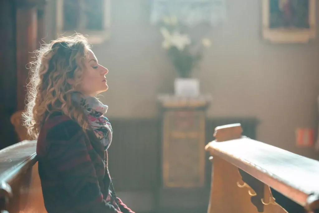 woman sitting in an empty church