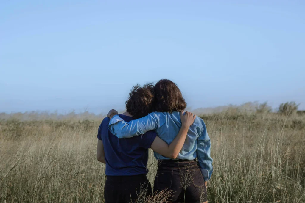 two female friends hugging, one just got out of a bad relationship