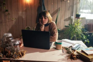 a woman bored at her computer, stuck in a comparison trap between her job and her friend's job