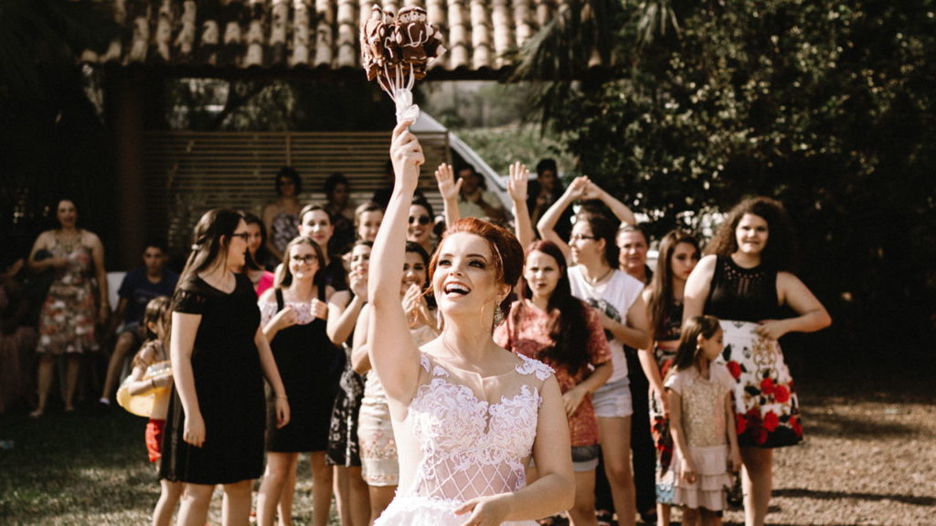bride throwing flower bouquet