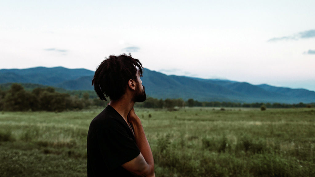 man looking over pasture